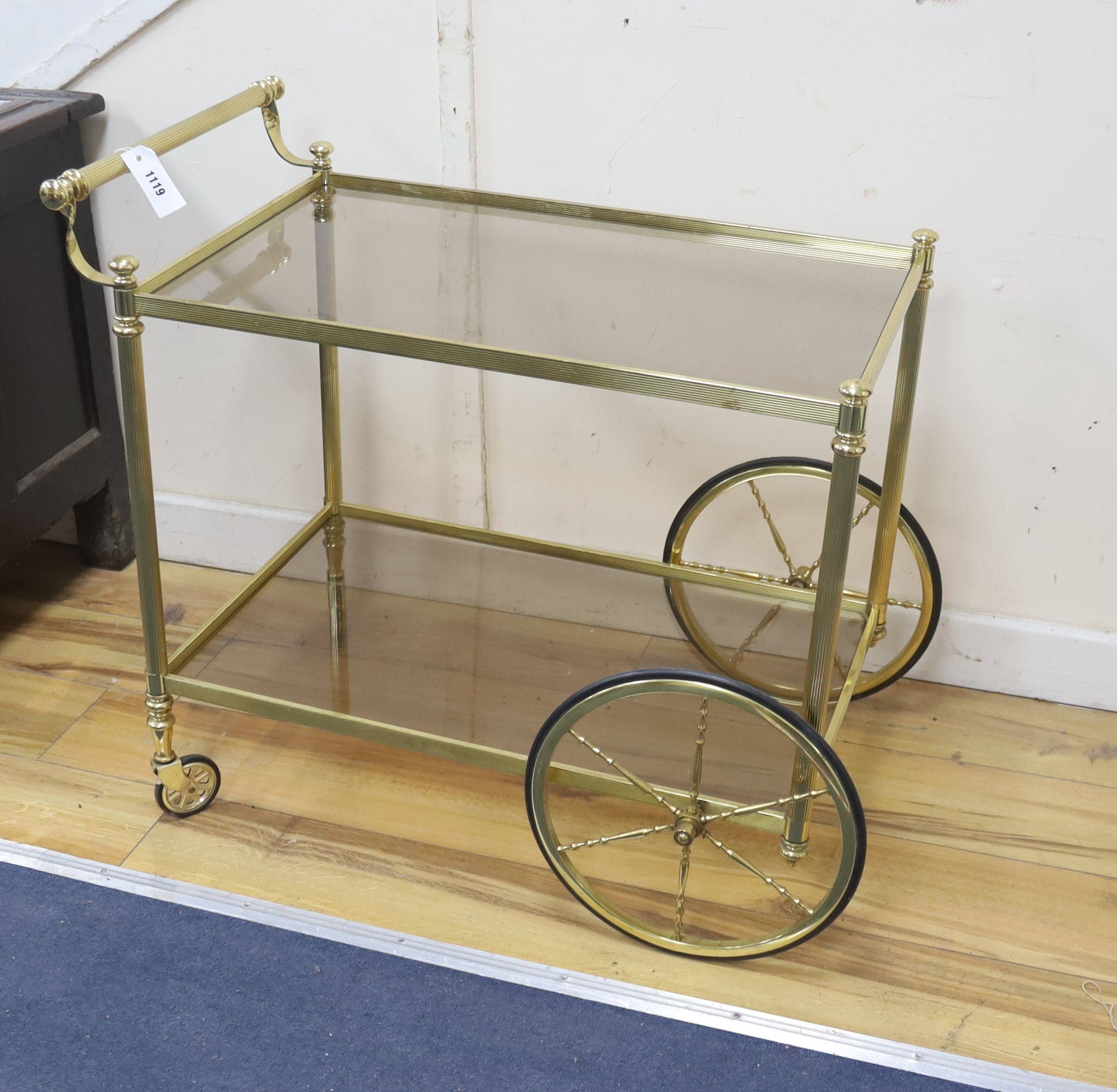 A Hollywood Regency brass and glass two tier drinks trolley, width 74cm, depth 44cm, height 70cm